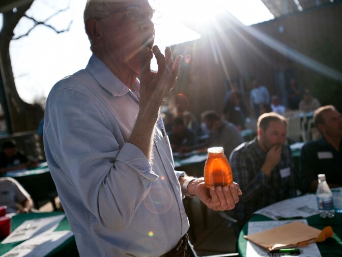 Max Eggman, a beekeeper from Tulare, Calif. tastes a specialty honey to see if it's authentic. Eggman is part of three generations of beekeepers. He attends a dinner for beekeepers across the country, hosted by beekeeper Mike Mulligan in Shafter, Calif. on Friday, March 1.