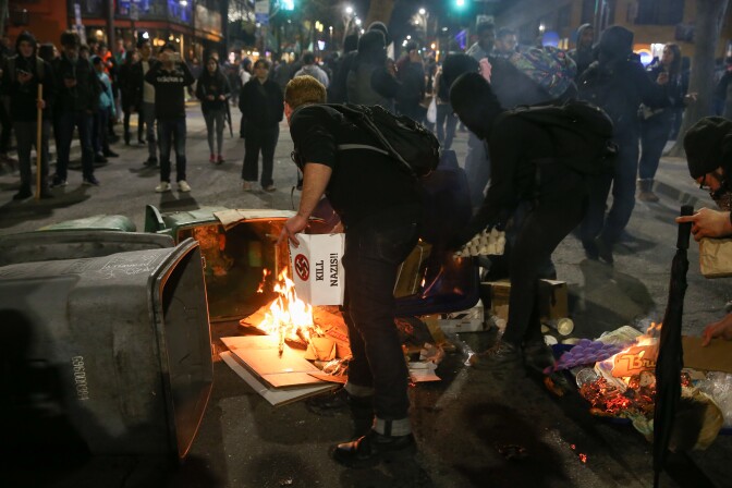 BERKELEY, CA - FEBRUARY 1: People protesting controversial Breitbart writer Milo Yiannopoulos burn trash and cardboard in the street on February 1, 2017 in Berkeley, California. A scheduled speech by Yiannopoulos was cancelled after protesters and police engaged in violent skirmishes. (Photo by Elijah Nouvelage/Getty Images)
