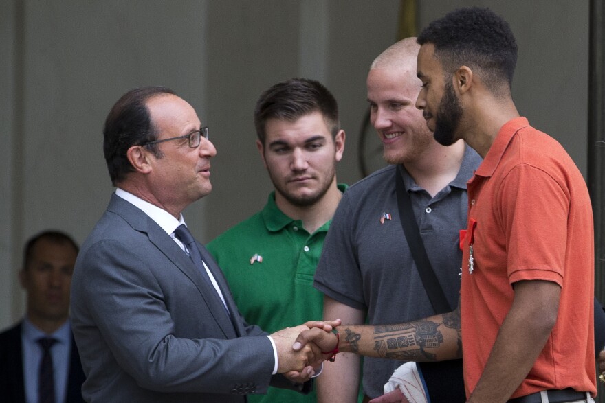 French President Francois Hollande (L) shakes hands with Anthony Sadler (R) next to off-duty US serviceman Spencer Stone (2nd R) and off-duty serviceman Alek Skarlatos after a reception at the Elysee Palace in Paris on August 24, 2015, during which they have been awarded with France's top Legion d'Honneur medal in recognition of their bravery after they overpowered the train attacker. AFP PHOTO / KENZO TRIBOUILLARD        (Photo credit should read KENZO TRIBOUILLARD/AFP/Getty Images)