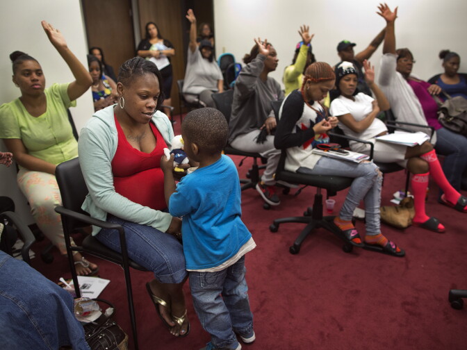 Kenisha Norwood, left, and her 3-year-old son Xavier attend a social support and empowerment class for pregnant mothers put on by Great Beginnings for Black Babies at Freeman Medical Arts Building on Monday, Feb. 23.
