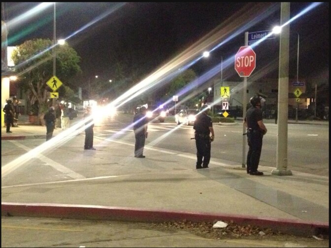 LAPD officers in riot gear ask a small group of people to leave the area at the intersection of 43rd Street and Leimert Boulevard Monday night. Officers declared an unlawful assembly and dispersed a crowd after a group of about 100 people became unruly near the location of a Trayvon Martin rally at Leimert Park.