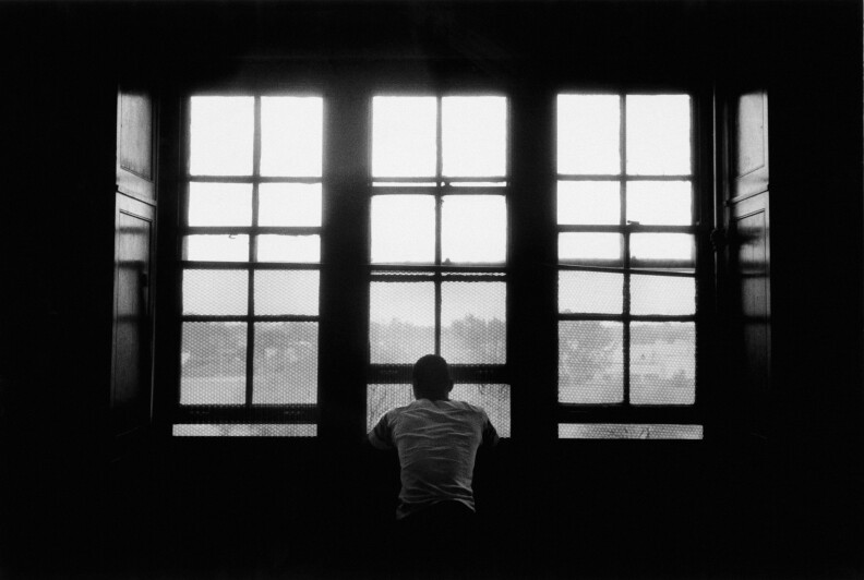 A person stares out a window.