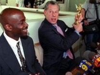 Los Angeles-based lawyer Stephen Yagman (R) displays an Oscar statuette during a press conference to publicize his client Anthony Hart's (L) federal civil rights action against LAPD chief Bernard Parks, head of the Acadamy of Motion Picture Arts and Sciences Robert Rehme, and Roadway Express, 06 April, 2000 in Venice, CA. 