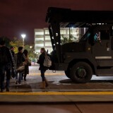 Students walk through campus after their buildings were cleared at Cal State Fullerton in Fullerton, Calif., Wednesday, Dec. 12, 2012. One of five robbery suspects, believed to be armed, allegedly barricaded himself inside a building on campus.