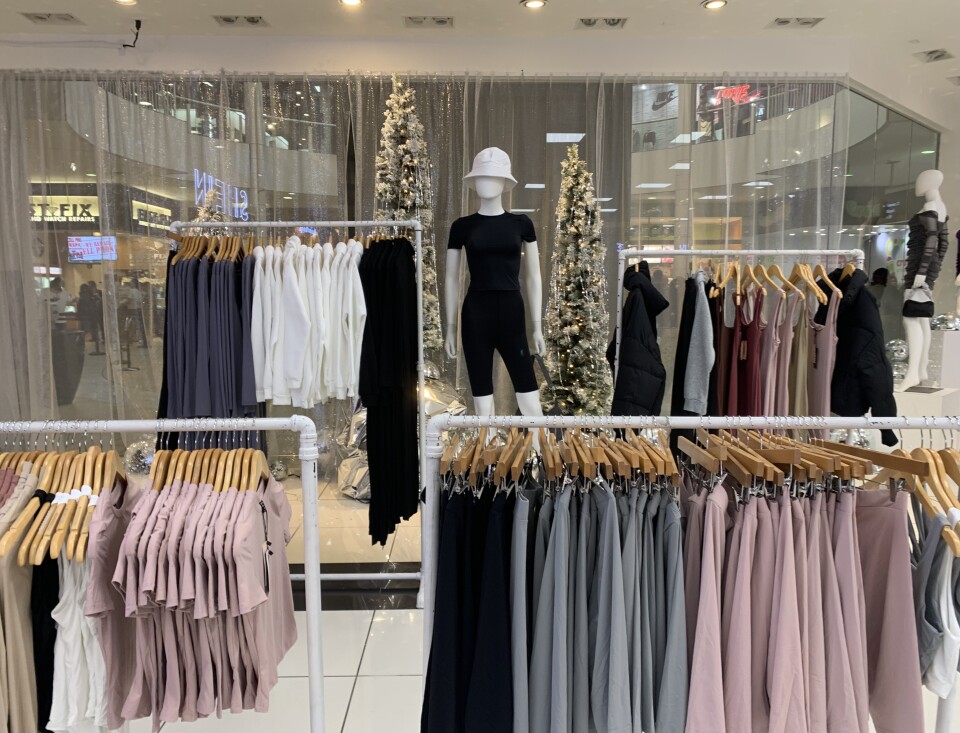 A mannequin stands amid racks of clothing at the Shein pop-up store. 