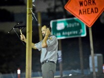 National Park Service ecologist Justin Brown uses a handheld antenna and scanner near the 101 freeway to listen for signals from radio-collared coyotes living near downtown Los Angeles early Thursday morning, June 4, 2016.

National Park Service Ecologist Justin Brown tracks coyotes living near downtown Los Angeles late Wednesday night June 3 and early Thursday morning June 4, 2015, in Los Angeles, CA. Some of the coyotes are fitted with radio collars.