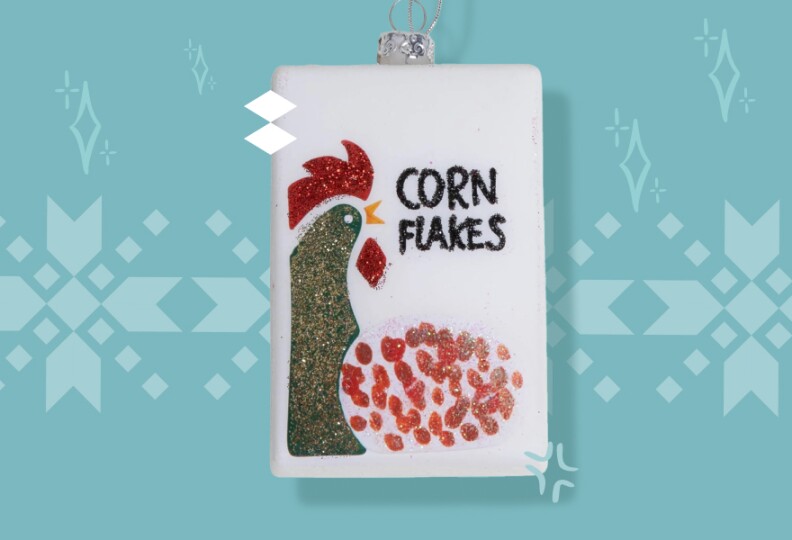 A white ornament hand painted to look like a corn flake box