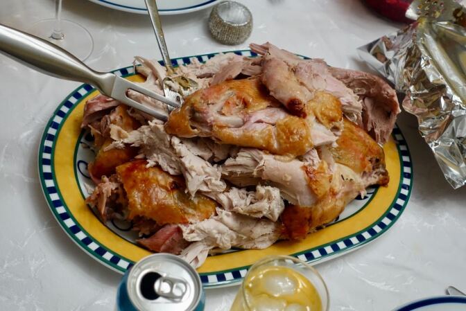 A plate is piled high with baked turkey