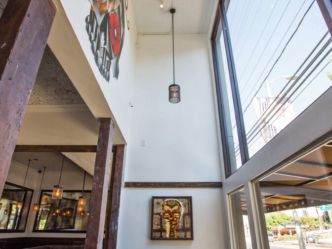 A skull with roses high on the wall inside Mercado restaurant is part of a series of murals by artist Carlos Nieto. 