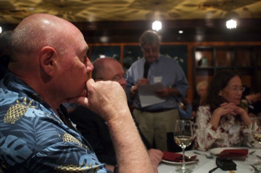 Holger Jensen listening as Richard Pyle reads off the names of deceased journalists
