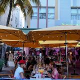 A couple drink at a restaurant on Ocean Drive in Miami Beach, Florida on June 26, 2020. - They are itching for a good time after months of lockdown, and may the coronavirus be damned: young adults in Florida are fueling a dangerous rise in COVID-19 infections. Feeling immortal, these fun-crazed people are finding ways to gather and party even though many bars and nightclubs remain closed as the Sunshine State reopened its economy this month. (Photo by CHANDAN KHANNA / AFP) (Photo by CHANDAN KHANNA/AFP via Getty Images)