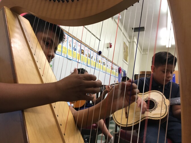 Students in Haddon STEAM Academy's mariachi band play during practice on June 3, 2016. The band meets as an elective class during the school day. Students play donated instruments and, during performances, wear authentic trajes (suits) valued at $300 apiece.