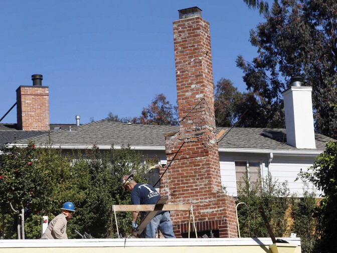 This Wednesday, Jan. 14, 2015, photo, shows a house being demolished that science fiction writer Ray Bradbury lived in, in the Cheviot Hills neighborhood of Los Angeles. It was the house where Bradbury wrote "Something Wicked This Way Comes," and when the bulldozer came to knock it down literary scholars and preservationists were aghast. The bright yellow home with the big bay windows where the author lived and worked for 54 years wasn't the first Los Angeles landmark to be flattened of course. The statuesque Ambassador Hotel, where Robert Kennedy was assassinated in 1968, is now the site of a public-school complex.
