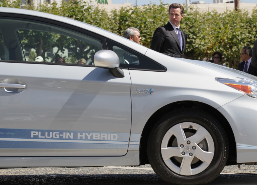 SAN FRANCISCO - AUGUST 25:  San Francisco mayor Gavin Newsom looks at a plug-in version of the popular Toyota Prius that is one of four on loan to the city for evaluation August 25, 2010 in San Francisco, California. With sales of electric and plug-in hybrid cars expected to increase in the coming years, the Bay Area Air Quality Management District has set aside $5 million to increase the number of electric car charging stations to 5,000 around the Bay Area. There are currently 120 stations in the area.  (Photo by Justin Sullivan/Getty Images)