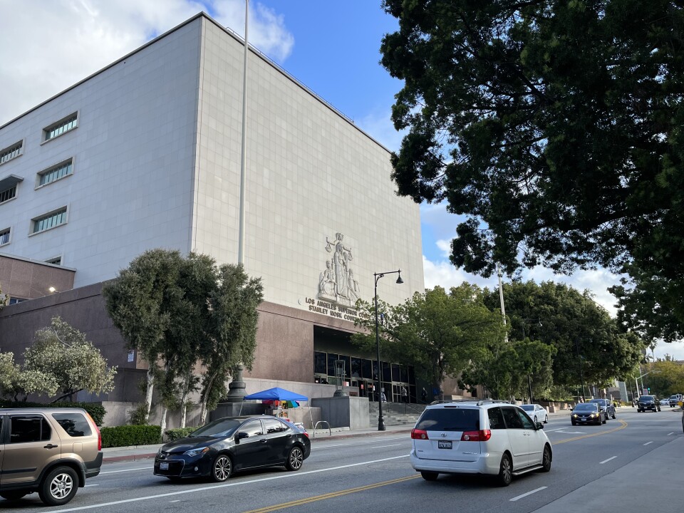 Cars drive past the entrance to the Stanley Mosk Courthouse in Downtown L.A., one of the nation’s busiest trial courts. 