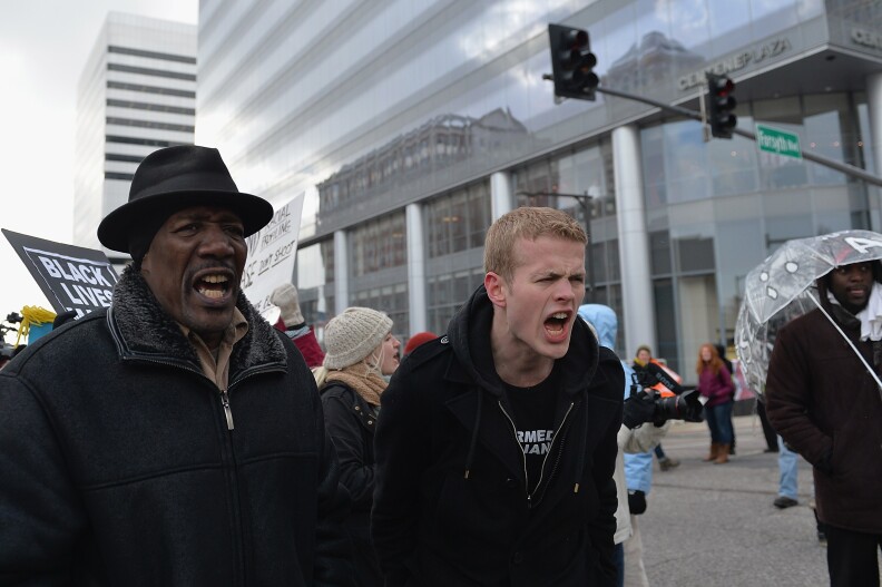 Demonstrators march during a peaceful protest November 17, 2014 streets in Clayton, Missouri. The governor of the US state of Missouri declared a state of emergency Monday and activated the National Guard ahead of a grand jury decision in the case of a black teenager shot and killed by a white police officer. Many fear an outbreak of violence if the St Louis County grand jury fails to indict Ferguson city police officer Darren Wilson in the August 9 death of 18-year-old Michael Brown.