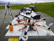 Researchers at the University of California, Davis are testing the use of small unmanned helicopters for pesticide spraying at farms and vineyards. (Photo: Hi-tech hobbyists Andreas Oesterer and Mark Harrison line up their homemade drones in Berkeley, Calif.)