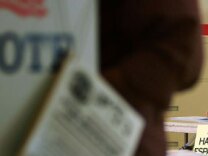 A sign reading, 'Se habla Espanol', identifies a bilingual election official as voters go to the polls for Super Tuesday primaries in the predominantly Latino neighborhood of Boyle Heights on February 5, 2008 in Los Angeles, California.