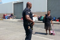 LAPD Officer Deon Joseph talks with one of the women who call Skid Row home.