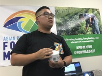 Kevin Liao, who works for Asian Pacific Islander Forward Movement, holds up one of the air quality sensors he's hoping to distribute throughout Alhambra and Monterey Park.