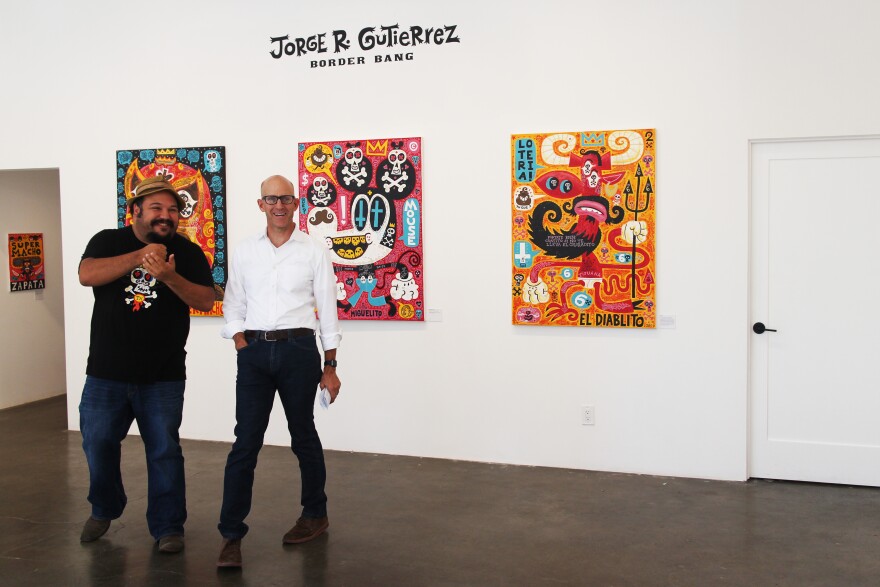 Artist Jorge Gutierrez and Frame host John Horn inside the Gregorio Escalante Gallery in Chinatown for the Border Bang show. 
