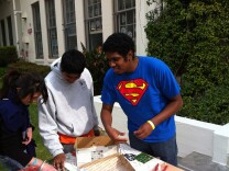 Justin Qualls of El Sereno, right, helps his brother and cousin work on a mosaic at Los Feliz Elementary School. They joined about a thousand people who volunteered to "beautify" the school grounds in honor  of Martin Luther King Jr. Day. 