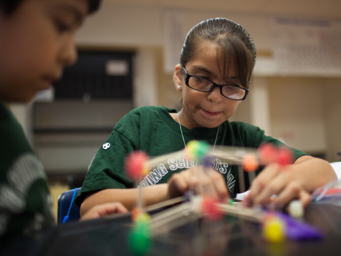 Emma builds a bridge out of gum drops and toothpicks during science camp at Cabrillo High School in Long Beach, Calif., on July 23.