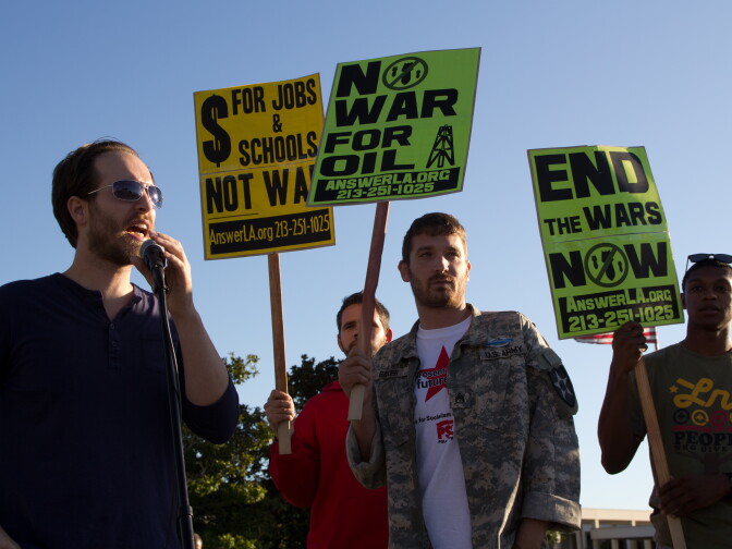 Members of the ANSWER Coalition protest on the 10th anniversary of the war in Afghanistan outside of the Federal Building in Los Angeles. 