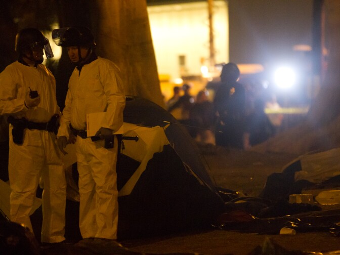 Some LAPD officers wore biohazard suits during the raid as they searched and began to dismantle the Occupy tents.