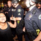 Protesters clash with police at Anaheim City Hall to show their outrage for the shooting death of Manuel Angel Diaz, 25, on July 24, 2012 in Anaheim, California. Diaz was fatally shot July 21 by an Anaheim police officer and has sparked days of protests by the angered community.