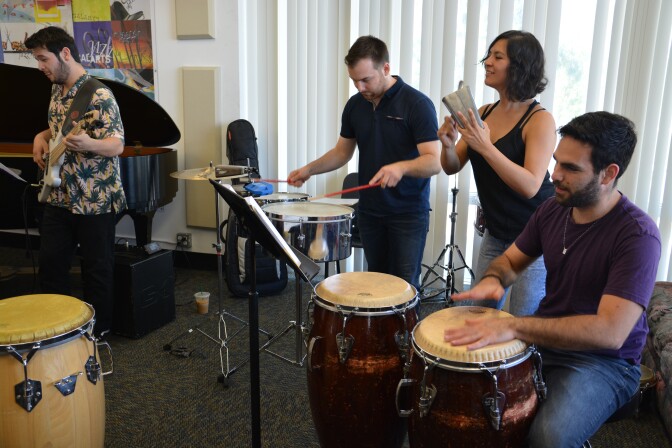 Members of the CalArts Salsa Band in rehearsal. (L-R): Josh Turner, bass; Carson Schafer, timbales; Emilia Moscoso, cowbell; Marcelo Bucater, congas.