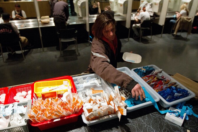 TO GO WITH AFP STORY by Laurent VU THE, Canada-society-drugs-health
A client of the Insite supervised injection Center in Vancouver, Canada, collects her kit on May 3, 2011. The Canadian Supreme Court is to settle a conflict between the government's wishes to close the center and the center's success in fighting the spread of AIDS among drug addicts. In eight years of existence, and with more 600 visits per day on average, Insite believes it has made advances in the fight against AIDS. And in a radius of 500 meters around the center, deaths by overdose dropped by 35 percent since the opening, according to a study published in the medical newspaper The Lancet.    AFP PHOTO/Laurent Vu The (Photo credit should read Laurent Vu The/AFP/Getty Images)