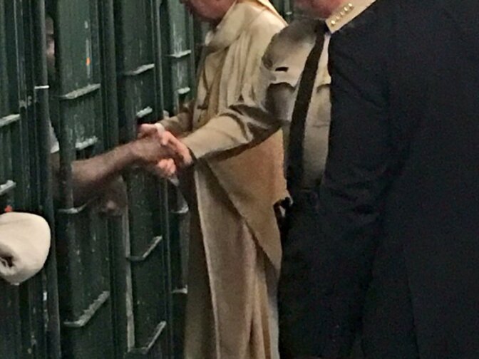 Los Angeles Archbishop José Gomez and Sheriff Jim McDonnell shake hands of prisoners at the Men's Central Jail who were too dangerous to participate in a Mass that Gomez celebrated at the jail on Christmas morning.