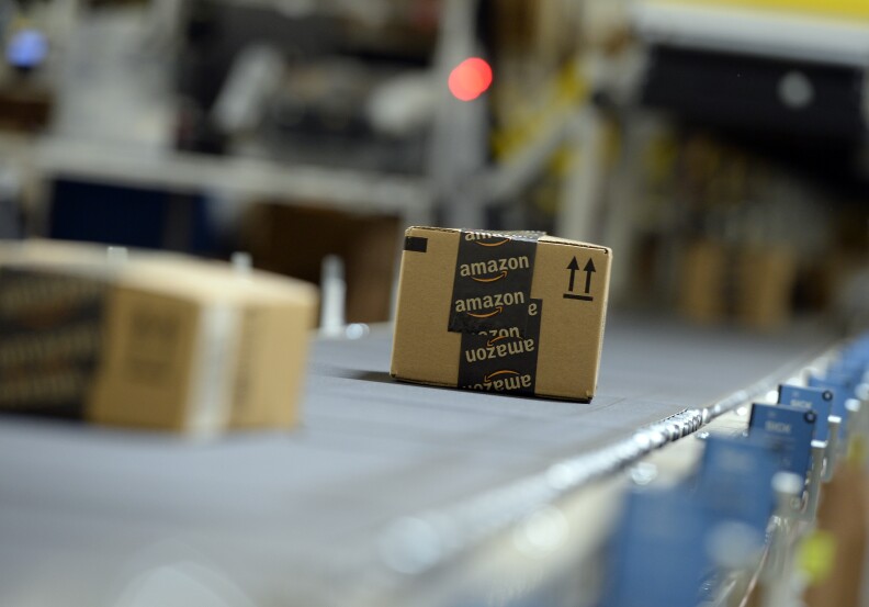 SAN BERNARDINO, OCTOBER 29: Shipping orders go by on a conveyor belt at Amazon's San Bernardino Fulfillment Center October 29, 2013 in San Bernardino, California. Amazon's 1 million square-foot facility in the hard hit San Bernardino County has created more than 800 jobs at the center. Fulfillment centers are where products sold by other vendors on Amazon.com store their inventory. (Photo by Kevork Djansezian/Getty Images)