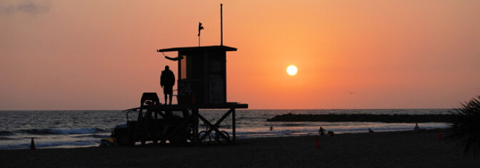 Beach areas are expected to be much cooler than inland areas the next four days. The National Weather Service has issued an Excessive Heat Warning for much of Southern California starting Friday. (Photo: A lifeguard at a lifeguard tower at sunset in Newport Beach.)