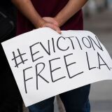 Renters and housing advocates attend a protest to cancel rent and avoid evictions amid Coronavirus pandemic on August 21, 2020, in Los Angeles, California. (Photo by VALERIE MACON / AFP) (Photo by VALERIE MACON/AFP via Getty Images)
