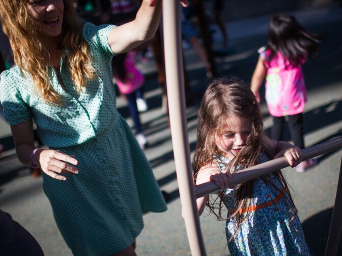 Christine McCleery spins her daughter Clementine on playground equipment at Echo Park Lake on June 15, 2013.