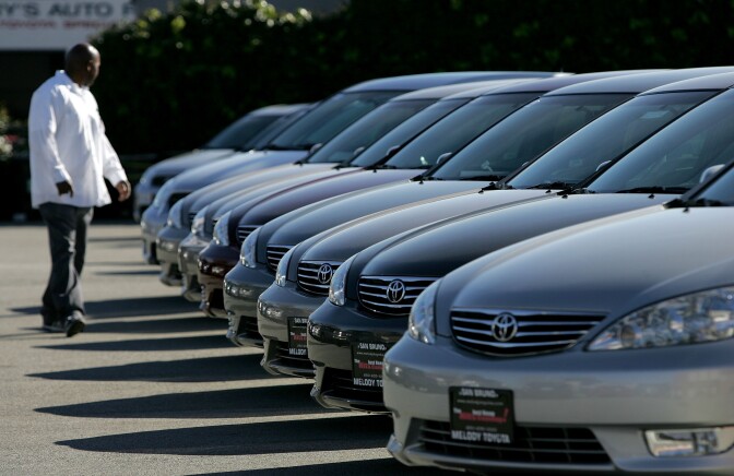 A man inspects new Toyota cars on display at Melody Toyota in San Bruno, California. 