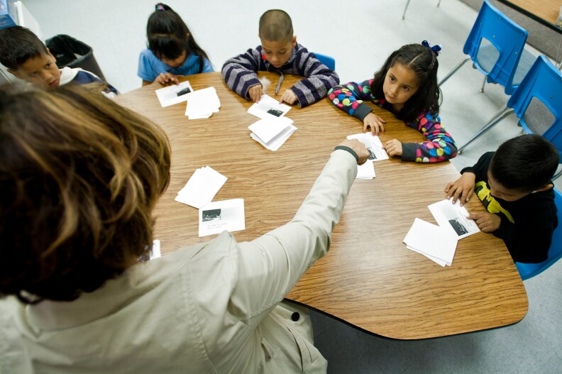 Teacher Susan Lopez reads a story along with her transitional kindergarten students.