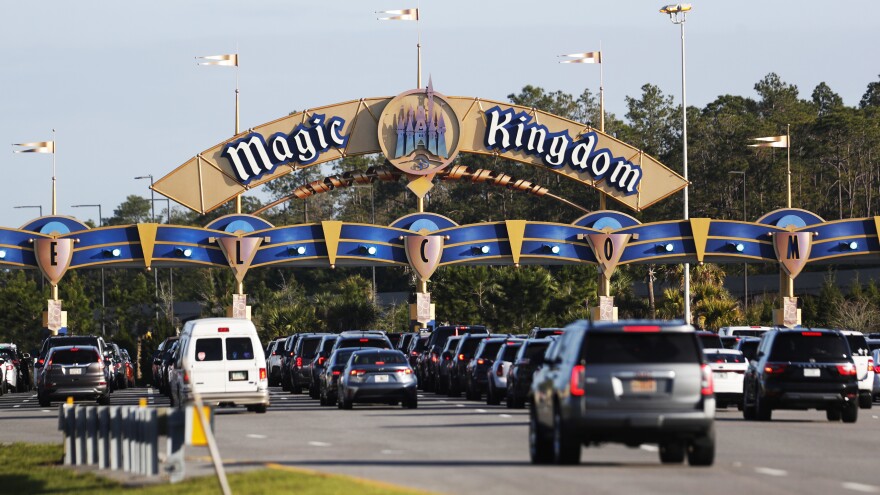 Cars wait in line to enter the Magic Kingdwom