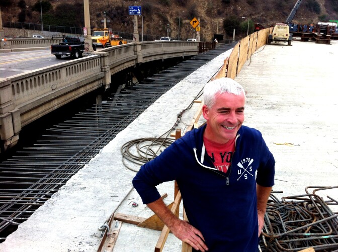 EnrichLA's Tomas O'Grady stands on the new L.A. River bridge that will join Figueroa St. and Riverside Drive. He and others are trying to convince the city to not demolish the historic bridge to the left and to, instead, turn it into something like New York City's High Line, for pedestrians and bicyclists.