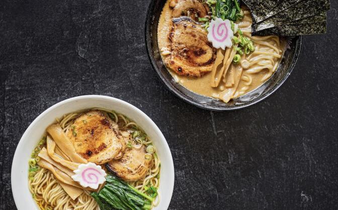 two bowls are filled with broth and ramen noodles