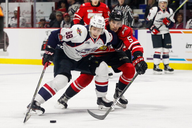 WINDSOR, ON - NOVEMBER 16: Defenceman Sean Durzi #5 of the Owen Sound Attack battles for the puck against forward Kirill Kozhevnikov #88 of the Windsor Spitfires on November 16, 2017 at the WFCU Centre in Windsor, Ontario, Canada. (Photo by Dennis Pajot/Getty Images)
