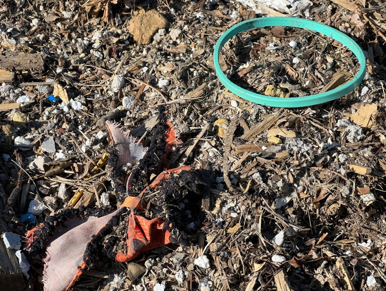 Wood, foam, cloth and rubber on what look like wood chips.
