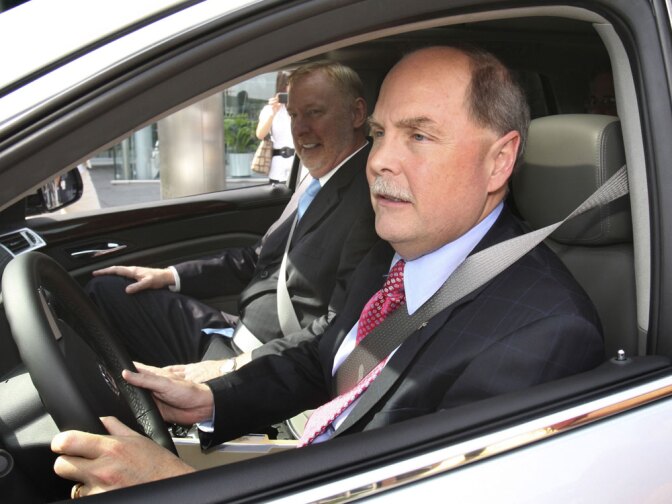 General Motors Corp. CEO Fritz Henderson drives a Cadillac with Tom Stephens, vice president of product development. GM and Chrysler are among the companies that have emerged as winners thanks to federal bailouts.