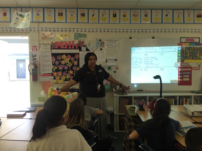 Magnolia Science Academy 7 third grade teacher Jennifer Rivera reminds students of the upcoming talent show before dismissing her class for the day.