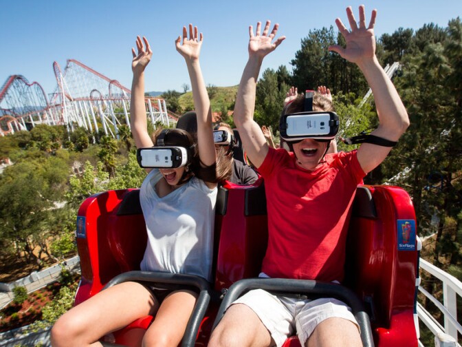 At Six Flags Magic Mountain in Valencia, Calif., riders of the New Revolution Virtual Reality Coaster wear VR goggles to play a video game while the roller coaster twists and turns.
