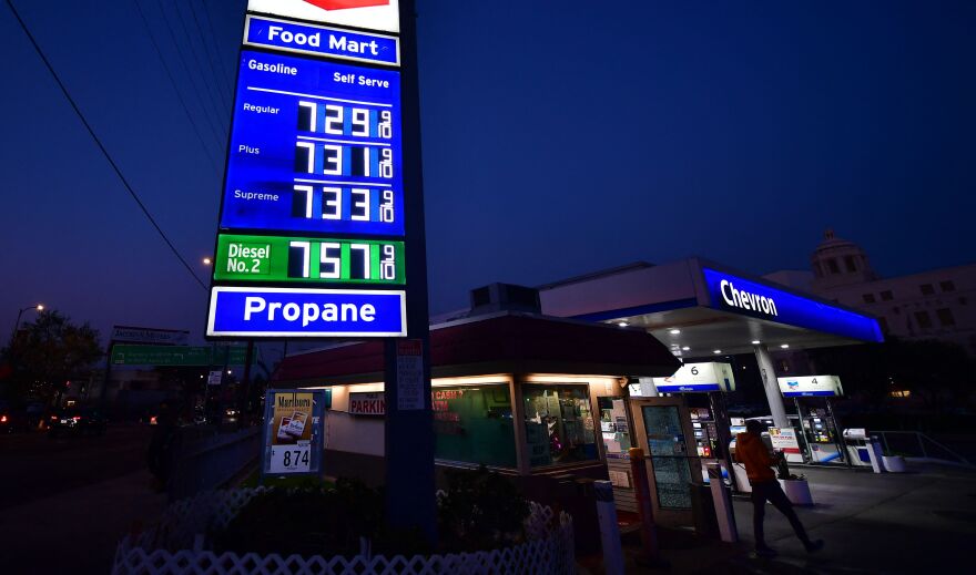 A lighted Chevron sign lists the price of a regular gallon of gas as $7.29 and Supreme at $7.33.