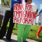 Protesters stand together as they hold a protest to ask their congress people to make immigration reform a reality on August 16, 2013 in Miami, Florida. 