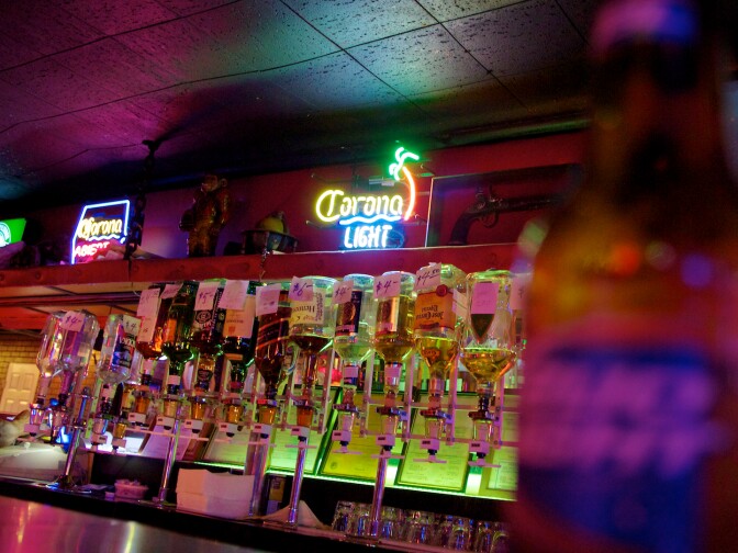 Drink prices are written on the bottles of liquor inside the Tango Room.